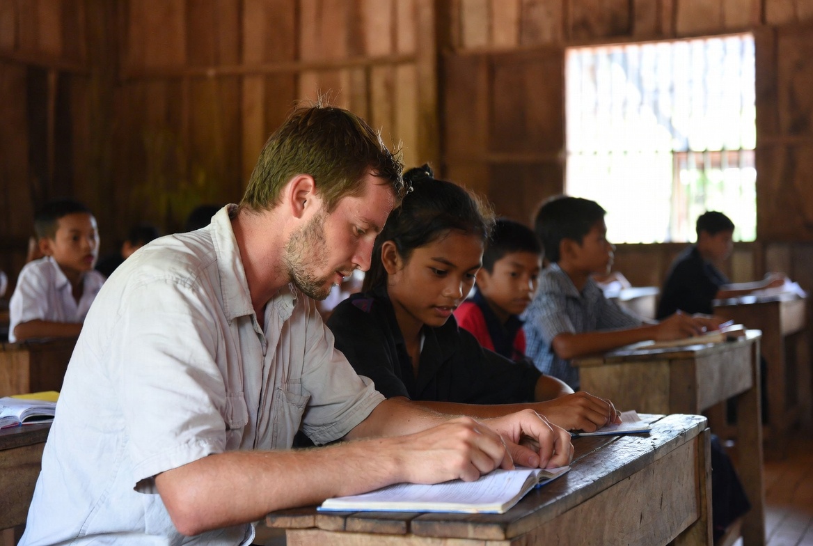 Teacher with Cambodian students in classroom